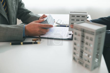Real estate brokers are bribing government officials with cash issue construction permits in areas where high rise buildings are prohibited. Concept bribing government officials to facilitate business