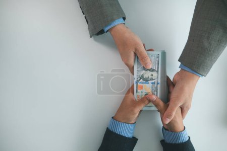Photo for Real estate brokers are bribing government officials with cash issue construction permits in areas where high rise buildings are prohibited. Concept bribing government officials to facilitate business - Royalty Free Image