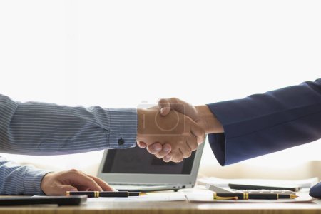 Geschäftsleute und Investoren schütteln sich die Hände als Symbol des Joint Ventures, nachdem sie gemeinsam diskutiert, beraten und Verträge abgeschlossen haben, um in Unternehmen zu investieren. Geschäftsleute schütteln Hände als Symbol der Zusammenarbeit