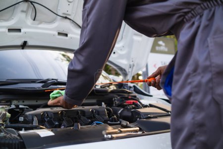 car service center mechanics are checking condition car and engine make sure they are ready use and in perfect condition according center warranty. periodic vehicle inspections for safety in driving.