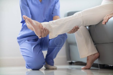 female doctor is helping a patient move her muscles after recuperating from a muscle injury and wanting to rehabilitate her to be able to use her normal daily life with continuous physical therapy.