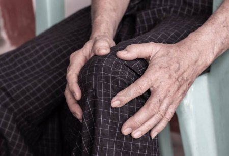 Photo for Knee joint pain in Asian Myanmar elder man. Concept of osteoarthritis, rheumatoid arthritis, patellar tendonitis, prepatellar bursitis, collateral ligament injury or baker cyst. - Royalty Free Image