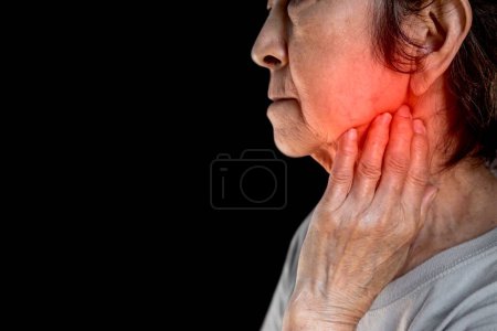 Photo for Inflammation at the jaw of Asian female patient. She feels wisdom toothache and lymph node pain. - Royalty Free Image