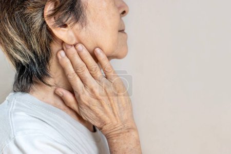 Photo for Pain at the jaw of Asian female patient. She feels wisdom toothache and lymph node pain. - Royalty Free Image
