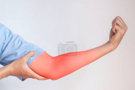Photo for Pain in the upper arm of Southeast Asian young man. Concept of elbow  and forearm pain, injury or muscle problem. - Royalty Free Image