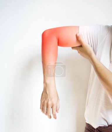 Photo for Pain in the upper arm of Southeast Asian young man. Concept of elbow  and forearm pain, injury or muscle spasm. - Royalty Free Image