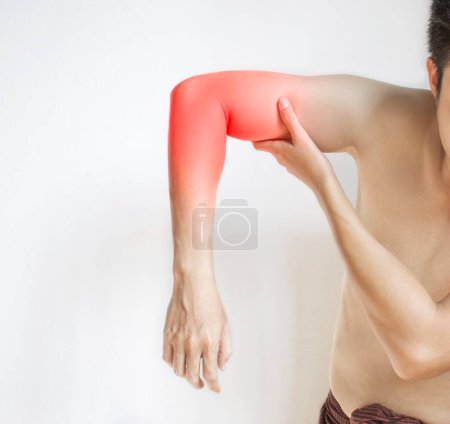 Photo for Pain in the upper arm of Southeast Asian young man. Concept of elbow  and forearm pain, injury or muscle spasm. - Royalty Free Image
