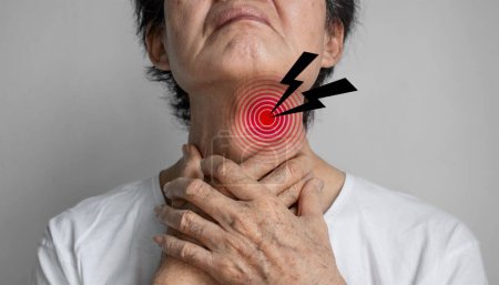 Photo for Pain at the neck of Asian man. Concept of sore throat, pharyngitis, laryngitis, esophagitis, thyroiditis, thyrotoxicosis, choking or dysphagia. - Royalty Free Image