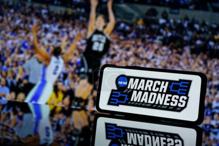 Photo for Kaunas, Lithuania - 2023 March 13: March madness logo on screen and NCAA basketball game play on TV in the background. High quality photo - Royalty Free Image