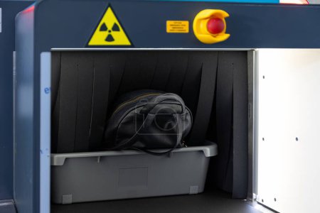 Nahaufnahme des Scannens von Reisegepäck mit einem Röntgenscanner an der Sicherheitskontrolle des Flughafens. Hochwertiges Foto