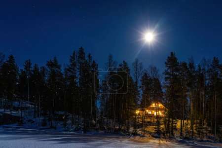 Photo for Winter fairy tale house in the middle of the snowy forest in the night - Royalty Free Image