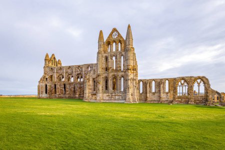 Photo for Sunset view of Whitby abbey overlooking the North Sea on the East Cliff above Whitby in North Yorkshire, England, UK - Royalty Free Image