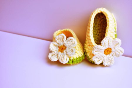 Photo for Crochet newborn baby girl shoes or pair of handmade booties for kids isolated in white background, pregnancy motherhood concept, first birthday party banner - Royalty Free Image