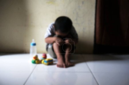 Photo for Blurred boy.  Boy covered his face with his hands. Stressed child. Domestic Family violence and aggression concept violence. concept for bullying, depression stress or frustration. - Royalty Free Image