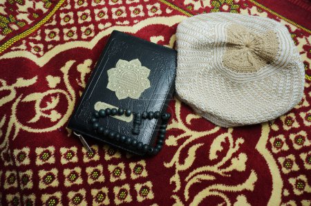 Téléchargez les photos : Al Coran With Indonesia Traduisez sur un tapis de prière. Le Coran est un livre sacré islamique pour les musulmans. - en image libre de droit