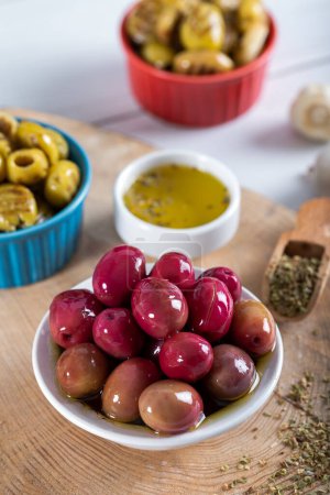 Photo for Red kalamata olives on wooden background. Red and green kalamata olives. - Royalty Free Image