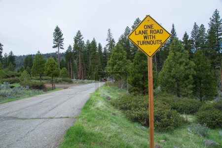 A sign near Blue Lake in the Modoc National Forest warns drivers that the road narrow to a single lane requiring use of turn outs for vehicles to pass each other.