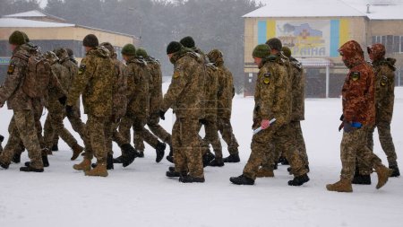 Photo for Kharkiv, Ukraine - January, 31, 2022: Ukrainian soldiers in military uniforms, with weapons, march in formation on the parade ground in winter. Russian-Ukrainian war 2022-2023. Ukrainian - Royalty Free Image