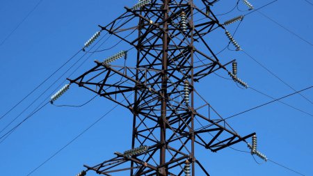 Foto de Torre de líneas de alta tensión. Cables eléctricos contra un cielo azul. Panorama. Concepto de energía, producción y transporte de energía eléctrica - Imagen libre de derechos