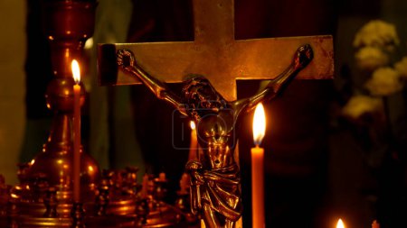 Photo for Church candles burn against the background of a cross depicting a crucifixion. Prayer and church services. Orthodox Church Holidays - Royalty Free Image