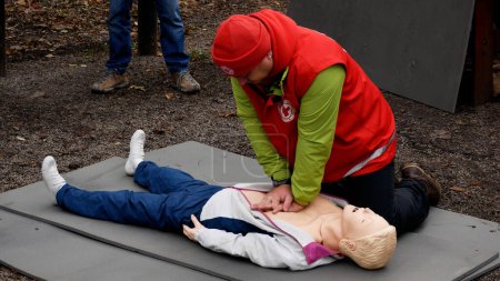 Photo for Kharkiv, Ukraine - November, 11, 2023: A medic on a mannequin shows how to perform indirect heart massage to an injured person. First aid. Human resuscitation. - Royalty Free Image
