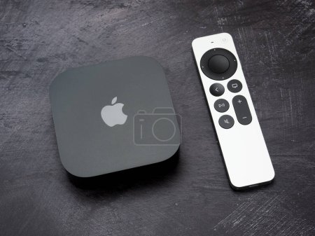 Bucharest, Romania - December 4, 2022: Product shot of the Apple TV 4k 2022 with WiFi and Ethernet, 128Gb RAM, and with Siri Remote, on gray background