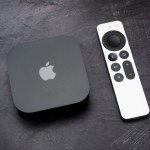 Bucharest, Romania - December 4, 2022: Product shot of the Apple TV 4k 2022 with WiFi and Ethernet, 128Gb RAM, and with Siri Remote, on gray background