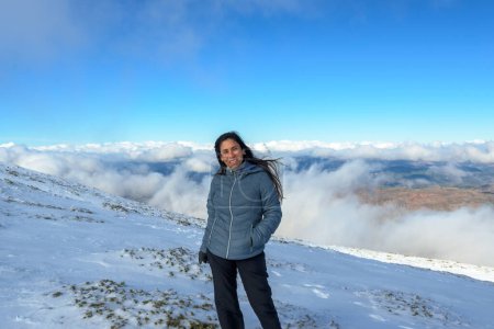 Photo for Portrait of latina woman in the snow above the clouds - Royalty Free Image