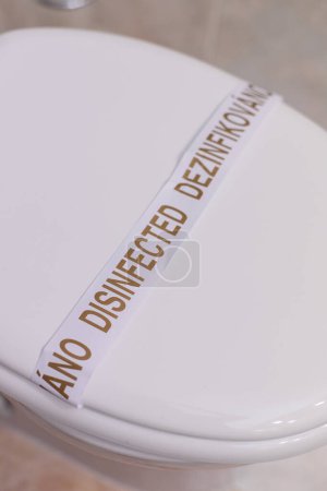 Photo for Disinfected Toilet Bowl in Hotel. washed toilet bowl with a sticker in a hotel close-up - Royalty Free Image