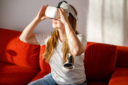 Frau sah Live-Streaming-Konzert in Virtual-Reality-VR-Brille auf Sofa im heimischen Wohnzimmer