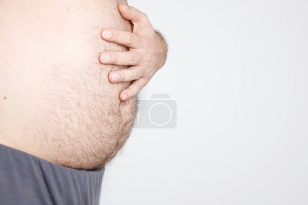 Photo for Male hairy belly on a white background. obesity - Royalty Free Image