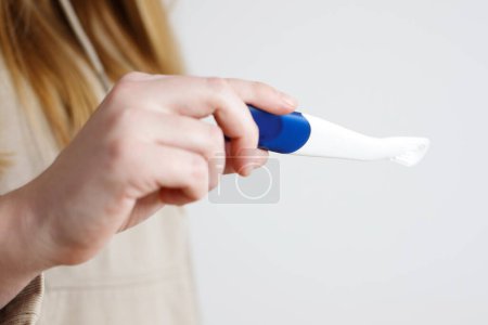woman with pregnancy test close-up