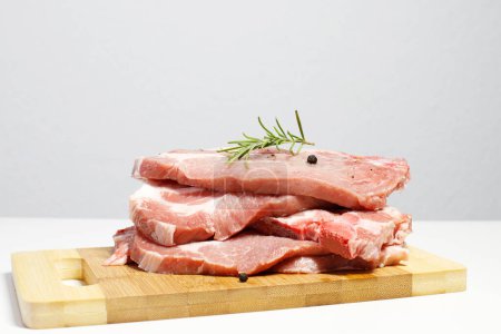 Photo for Fresh raw pork meat, pork tenderloin steaks ready to be cooked in kitchen - Royalty Free Image