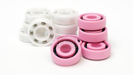 White and pink plastic ball bearings on a white background