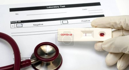 Photo for Doctor holding a test kit for viral disease COVID-19 - Royalty Free Image