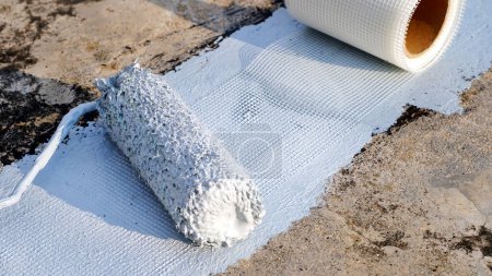 Photo for Hand painted gray flooring with paint roller for waterproof, reinforcing net. Repairing waterproofing deck flooring. - Royalty Free Image