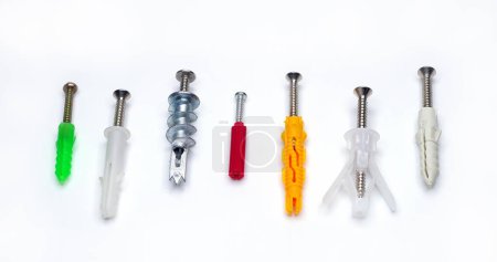 Photo for Wall plugs, also known as screw anchors or dowels, in different colors and sizes, on white background - Royalty Free Image