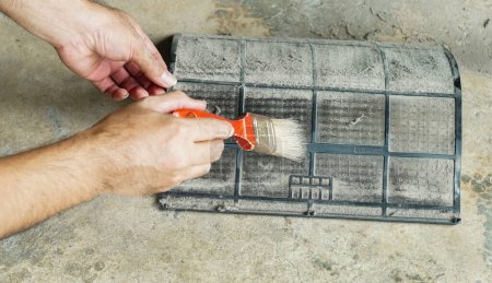 Photo for Close up of person cleaning house air filter. Filter air conditioner. - Royalty Free Image