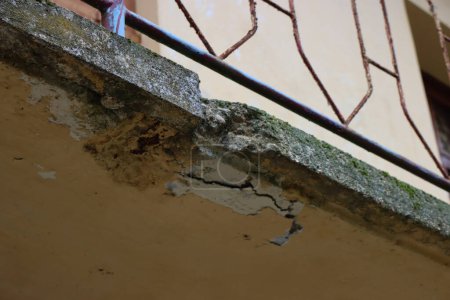 Balcón dañado en una casa antigua en Italia. Balcón con hormigón agrietado. Reparación de balcón, grietas en estructura de hormigón armado