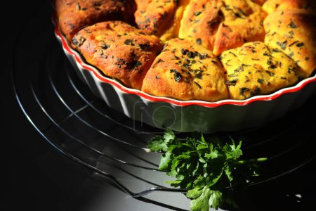 Turmeric curcuma and parsley bread . Healthy turmeric Bread in a cake pan on a cooling rack
