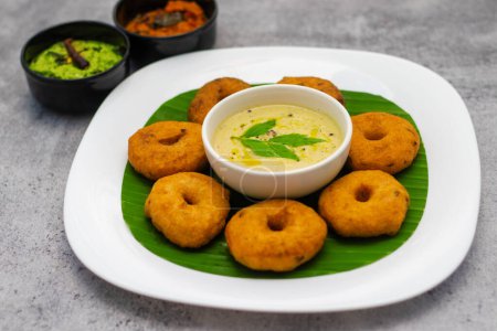 selective focus of South Indian famous food "Medu Vada" with Sambar and coconut chatney.