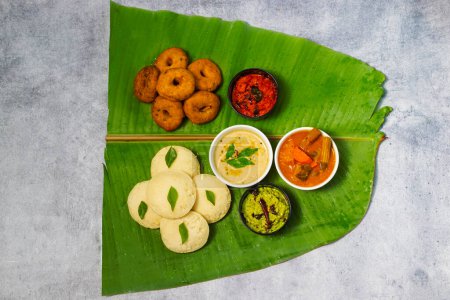 selective focus of famous South Indian food "Idli Vada", "Medu Vada","dosa" with Sambar,coconut chatney and tomato chatney.