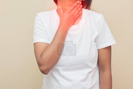 Photo for Imitative representation of an Indian lady feeling throat discomfort. - Royalty Free Image