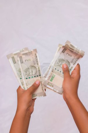 selective focus counting Indian five hundred rupees currency notes.