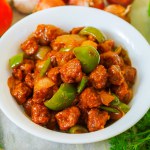 selective focus of Soya ManchurianChili Soya bean chunks recipe. with a decorative background.