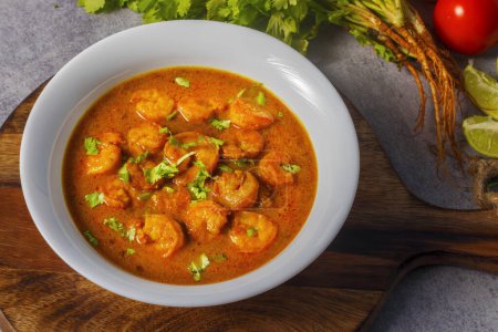 Indian food prawn curry masala with coriander leaves.