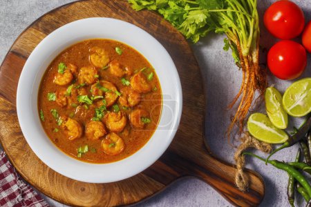 Indian food prawn curry masala with coriander leaves.