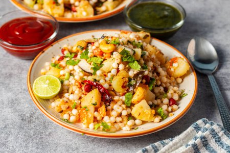 Photo for Sabudana Khichdi is a gluten-free Indian dish made with soaked tapioca pearls, potatoes, peanuts, and spices. Its popular during fasting days. - Royalty Free Image