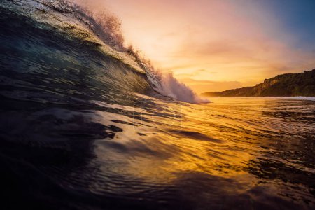 Photo for Perfect surfing wave crashing in ocean with warm sunset tones. - Royalty Free Image