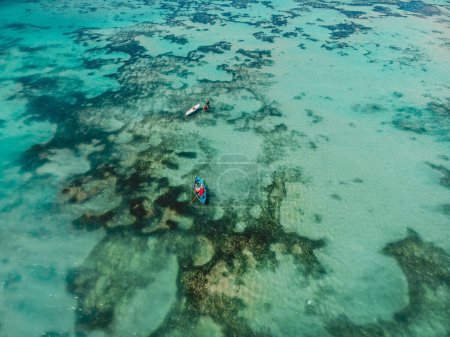 Photo for Turquoise ocean water and local fisherman on boat, aerial view in Bali island - Royalty Free Image